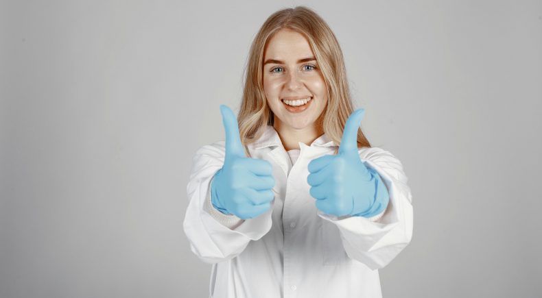 Smiling woman giving a thumbs up